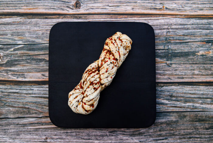 Marinated string cheese from King Cheese on a wooden table.